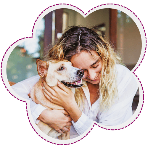 Woman embracing her happy dog