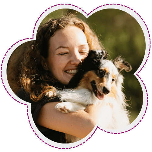 Woman happy, hugging dog