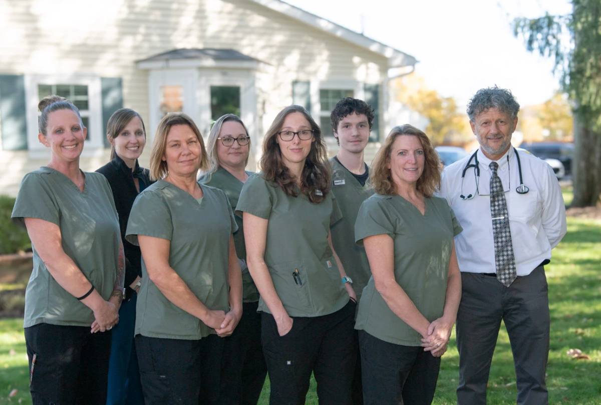 Team members standing with doctor