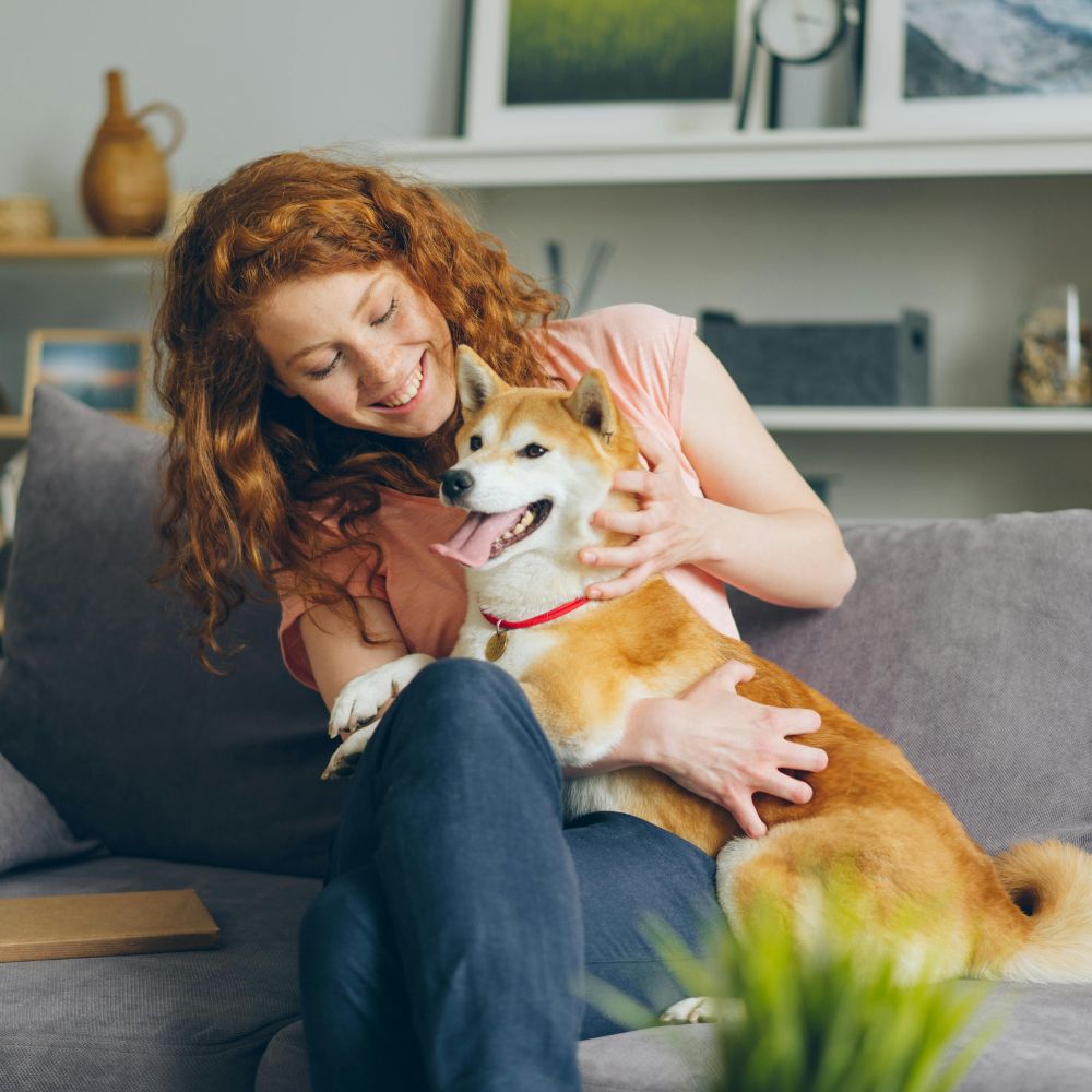 Woman cuddling with dog